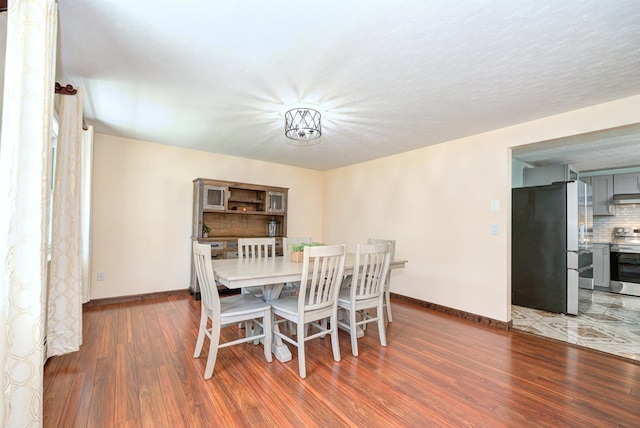 dining area with wood finished floors and baseboards