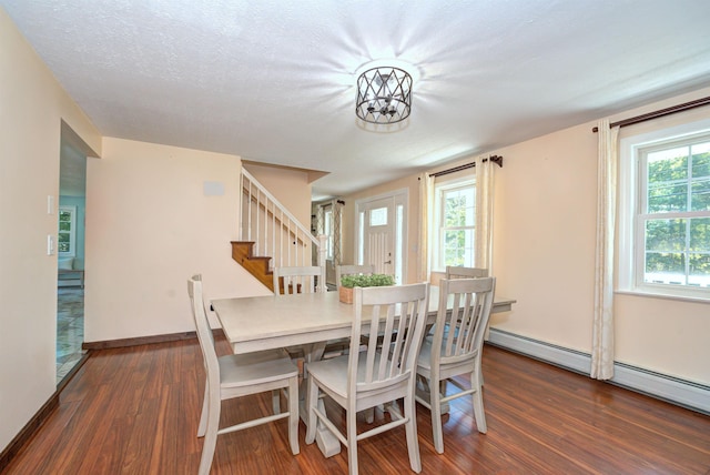 dining space featuring stairway, wood finished floors, a wealth of natural light, and baseboards