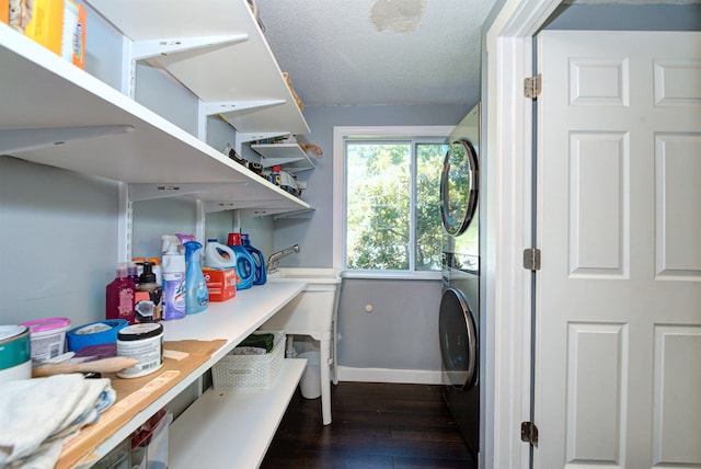 storage area featuring stacked washer / drying machine