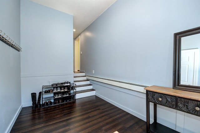 interior space featuring recessed lighting, a baseboard heating unit, wood finished floors, baseboards, and stairs