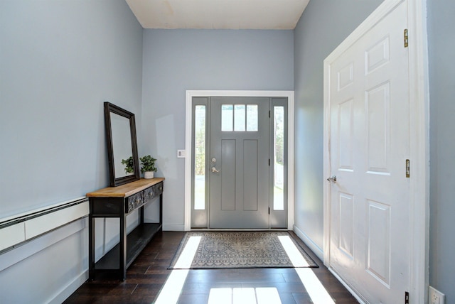 foyer featuring dark wood finished floors and baseboards