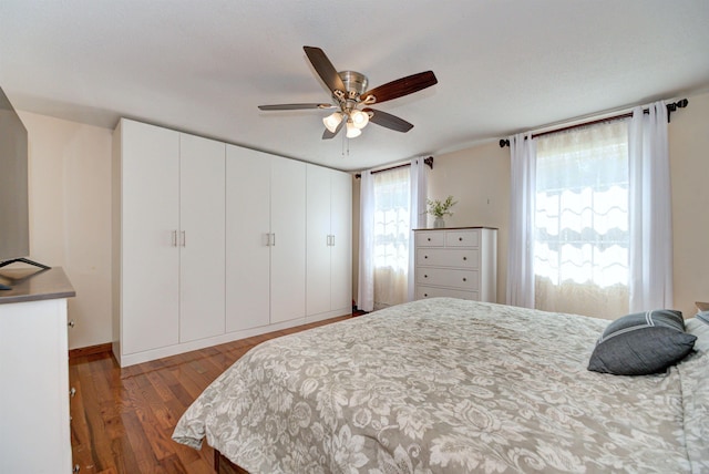 bedroom with dark wood-type flooring and a ceiling fan