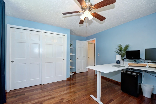 office space with a ceiling fan, dark wood-style flooring, and a textured ceiling