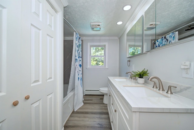 bathroom with ornamental molding, a sink, a textured ceiling, and baseboard heating