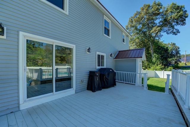 wooden deck with a yard, area for grilling, and fence