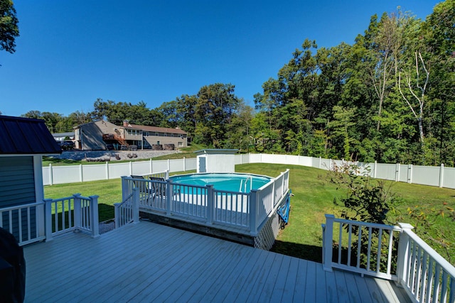 wooden deck with a yard, a fenced backyard, and a fenced in pool