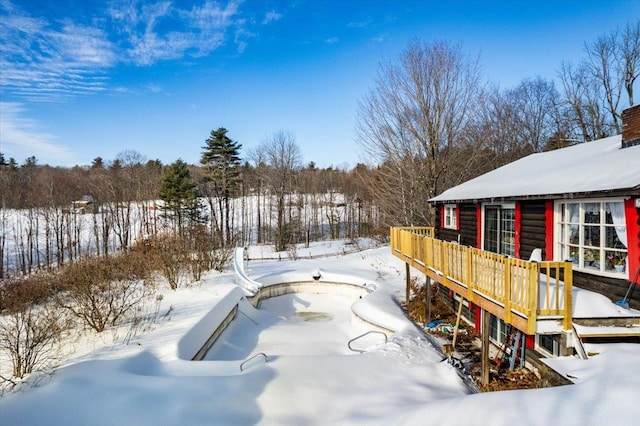 snowy yard with a wooden deck