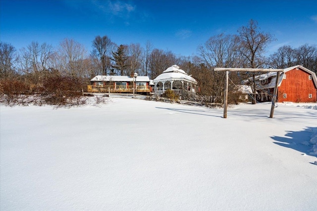 yard covered in snow with a gazebo