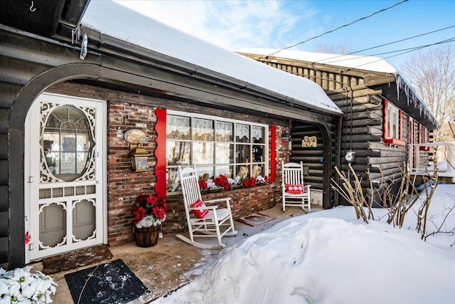 exterior space with a porch and log siding