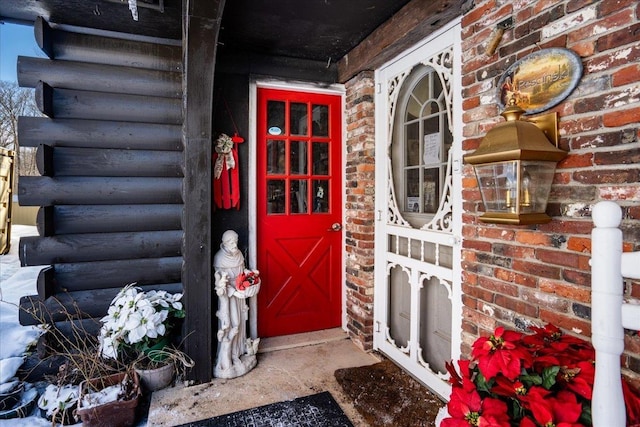 view of exterior entry with brick siding