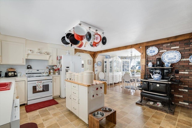 kitchen with white appliances, light countertops, light floors, white cabinetry, and open shelves