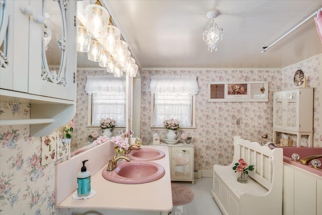 bathroom with double vanity, wallpapered walls, a baseboard radiator, and a sink