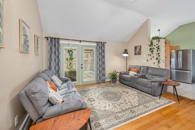 living area featuring lofted ceiling, a baseboard heating unit, french doors, and light wood-style floors