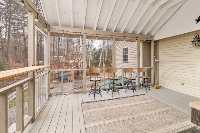 sunroom / solarium with lofted ceiling and a healthy amount of sunlight