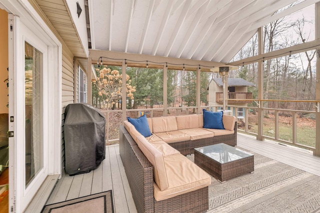 sunroom / solarium featuring lofted ceiling