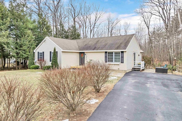 single story home with roof with shingles, driveway, and central air condition unit