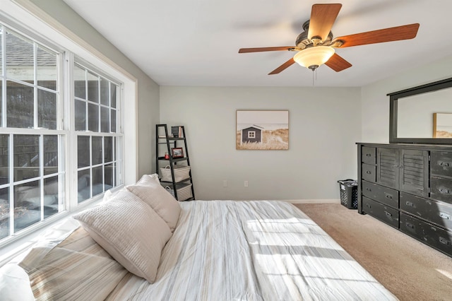 bedroom with carpet floors, a ceiling fan, and baseboards