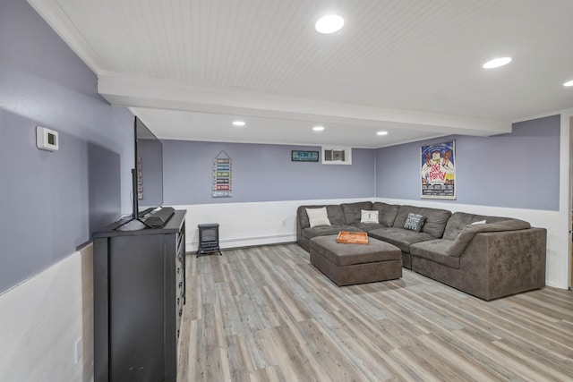 living room featuring light wood-type flooring, beam ceiling, baseboard heating, and recessed lighting