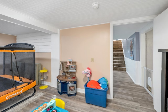 playroom with baseboards and wood finished floors