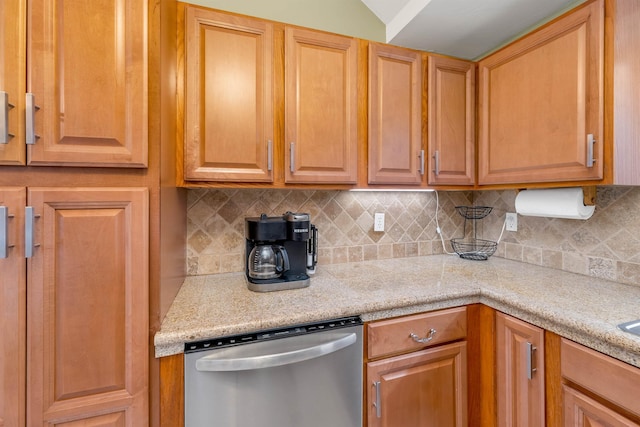 kitchen featuring light countertops, dishwasher, and backsplash