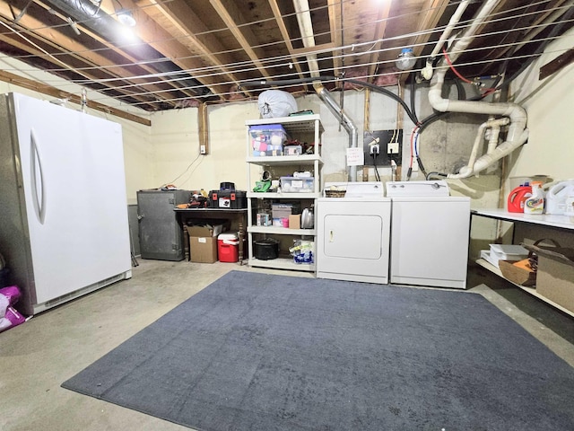 unfinished below grade area with washer and dryer and freestanding refrigerator