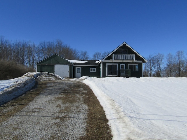 view of front of home featuring a balcony, a garage, and central AC