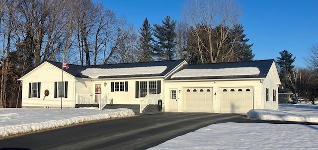 view of front of property with an attached garage and aphalt driveway