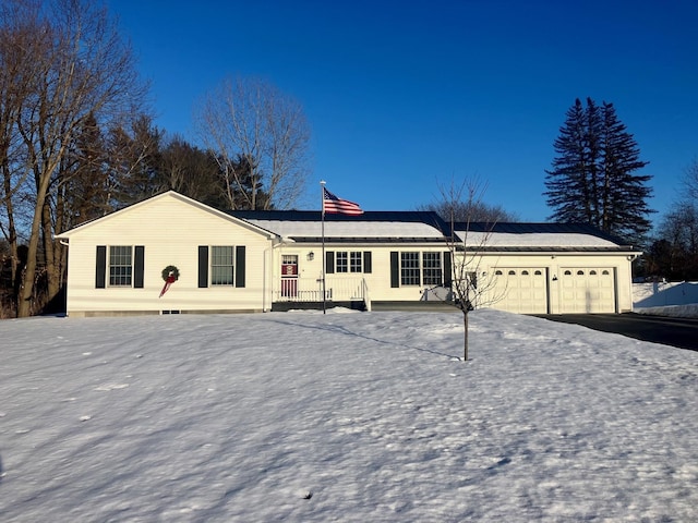 single story home featuring a garage and driveway