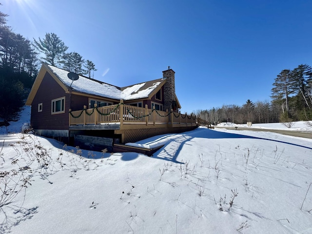 exterior space with a chimney and a deck