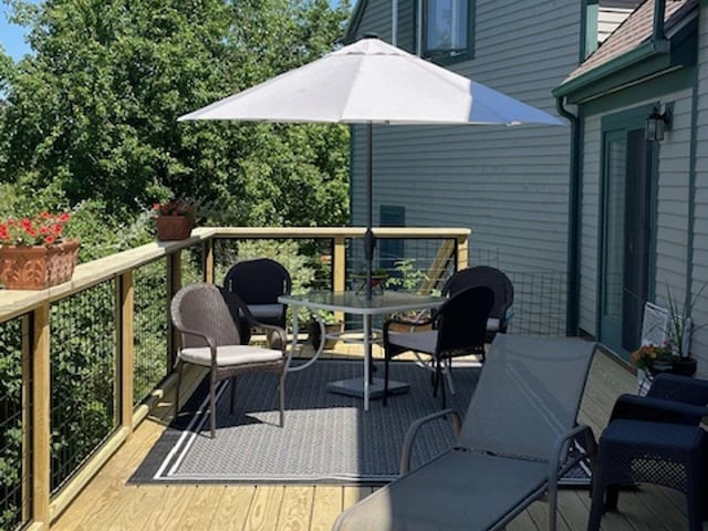 wooden terrace featuring outdoor dining space