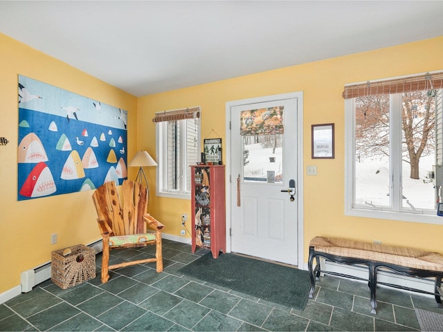 entryway featuring a baseboard radiator and baseboards