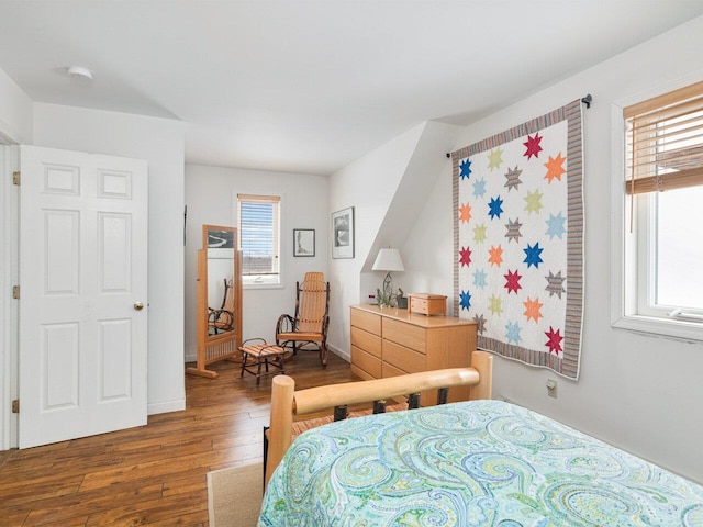 bedroom featuring hardwood / wood-style flooring and baseboards