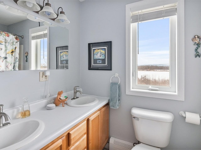 full bath with a healthy amount of sunlight, a baseboard radiator, and a sink