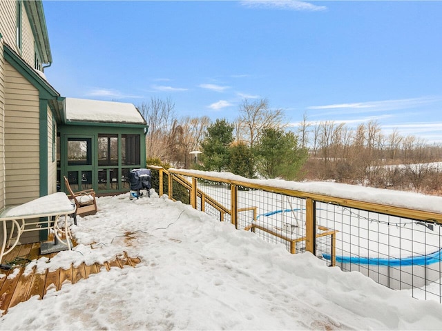 snowy yard with a sunroom