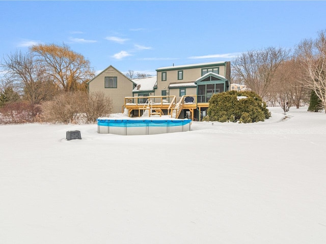 snow covered property featuring a deck