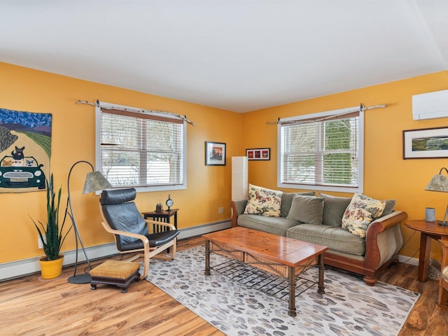 living room featuring a wall unit AC, baseboards, and wood finished floors