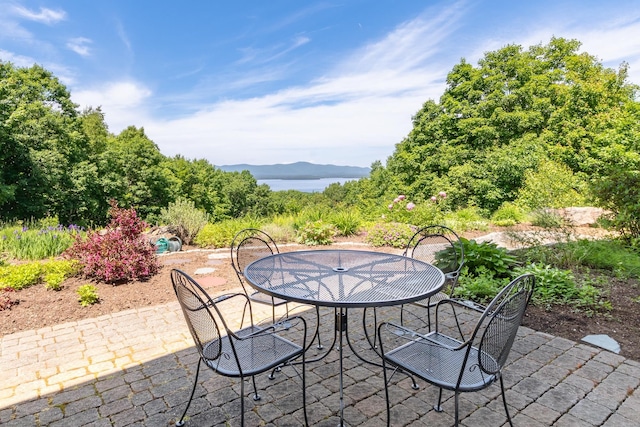 view of patio featuring outdoor dining area and a mountain view