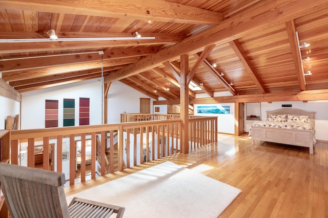 sitting room with wooden ceiling, lofted ceiling with beams, track lighting, and wood finished floors