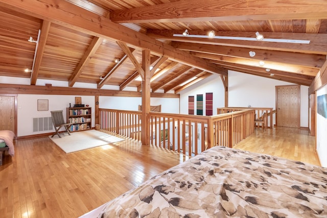 additional living space with lofted ceiling with beams, wooden ceiling, visible vents, baseboards, and hardwood / wood-style floors