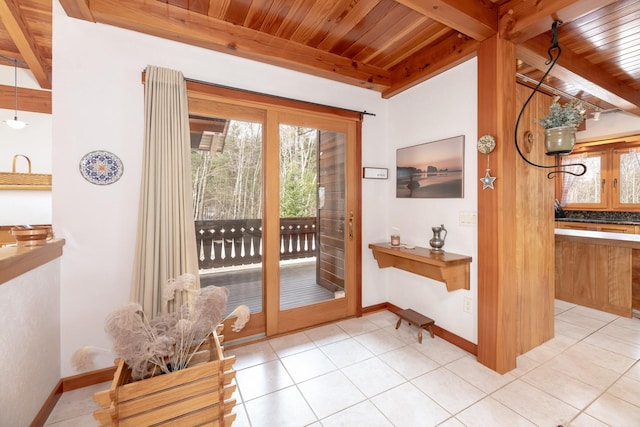 doorway to outside featuring wood ceiling, light tile patterned floors, beam ceiling, and baseboards