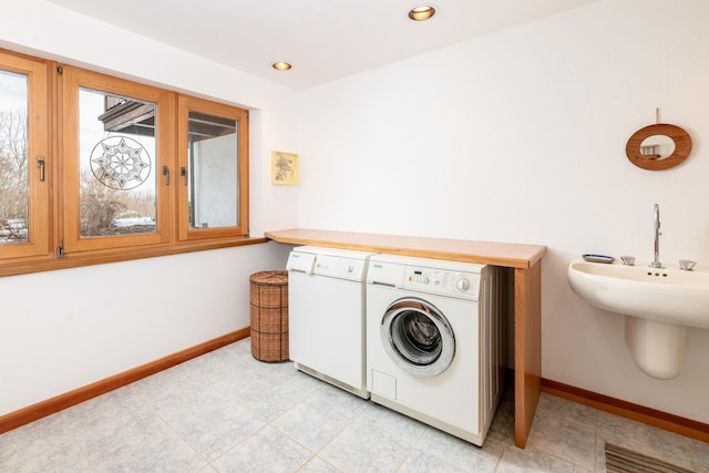 laundry area featuring recessed lighting, laundry area, washer and clothes dryer, and baseboards