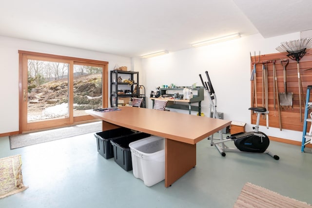 office featuring baseboards and finished concrete floors