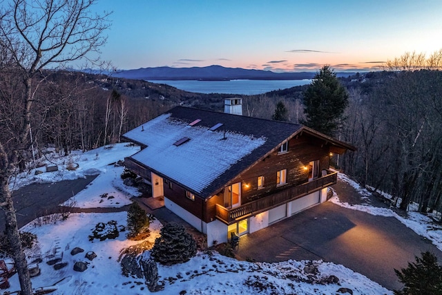 snowy aerial view with a forest view