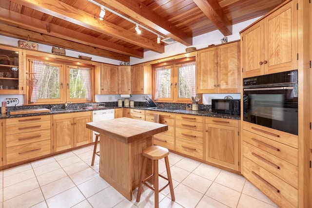 kitchen featuring light tile patterned floors, wood ceiling, a sink, wood counters, and black appliances