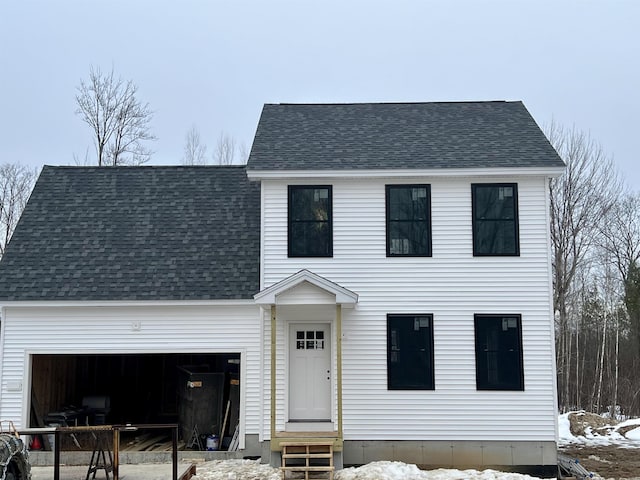 view of front of home with entry steps, roof with shingles, and an attached garage