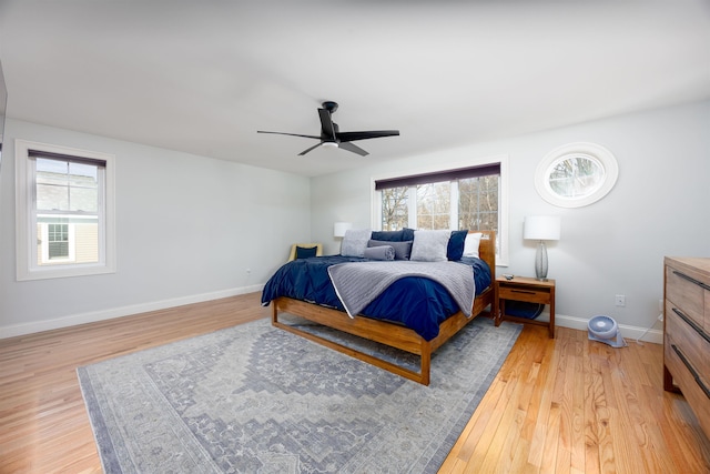 bedroom with baseboards, ceiling fan, and light wood finished floors