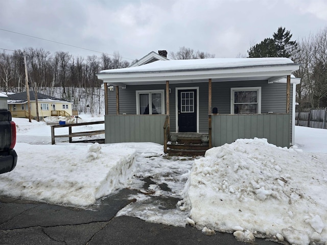 view of front of house featuring a porch and fence