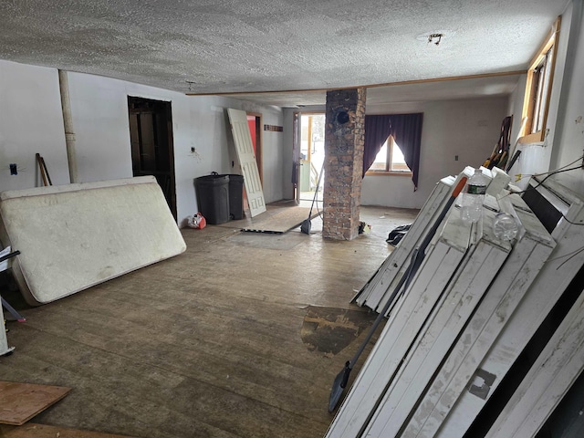 living room featuring a textured ceiling and wood finished floors