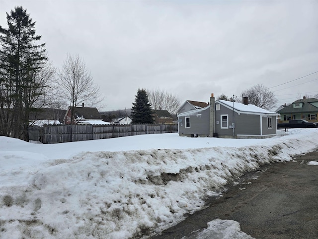 exterior space featuring fence and a chimney