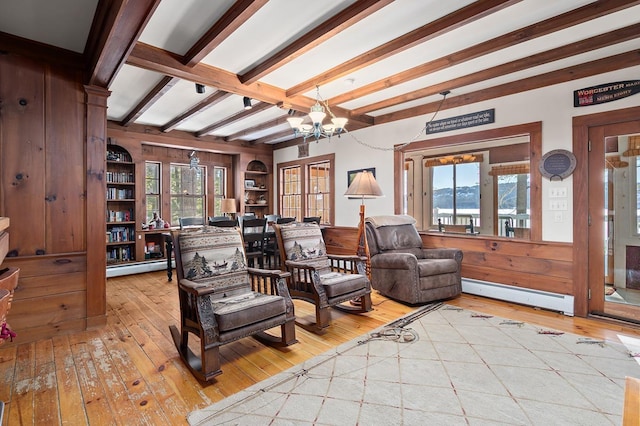 living area featuring a chandelier, a baseboard radiator, and wood-type flooring